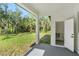 Covered patio with view of the backyard, featuring a convenient outdoor restroom at 14009 Daniels Ave, Port Charlotte, FL 33953