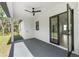 Covered patio with ceiling fan and access to backyard, offering indoor-outdoor living at 14009 Daniels Ave, Port Charlotte, FL 33953