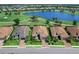 Aerial view showcasing the homes proximity to a golf course, lake, and lush tropical landscaping at 15037 Montello Way, Lakewood Ranch, FL 34211