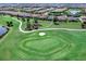 Wide aerial view of golf course and neighborhood highlighting the home's golf course location and landscaping at 15037 Montello Way, Lakewood Ranch, FL 34211