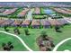Aerial view of neighborhood with a golf course, lakes, and manicured lawns surrounding single Gathering homes at 15037 Montello Way, Lakewood Ranch, FL 34211