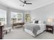 This bedroom has a ceiling fan, an area for a desk, and large windows for natural light at 15037 Montello Way, Lakewood Ranch, FL 34211