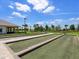 Bocce ball courts with manicured lawns and palm trees in a vibrant, sunny setting at 15037 Montello Way, Lakewood Ranch, FL 34211
