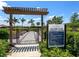 Community garden entrance with a welcome sign, raised garden beds, and green landscaping at 15037 Montello Way, Lakewood Ranch, FL 34211