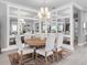 Elegant dining room with wood table, white chairs, and decorative wall mirror at 15037 Montello Way, Lakewood Ranch, FL 34211