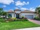 Charming home with lush landscaping, a two-car garage, and a tile roof at 15037 Montello Way, Lakewood Ranch, FL 34211