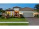 Beautifully landscaped home with tile roof, elegant entryway, and well-maintained lawn at 15037 Montello Way, Lakewood Ranch, FL 34211