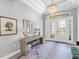 Elegant foyer features a chandelier, decorative mirror and table, and a patterned rug at 15037 Montello Way, Lakewood Ranch, FL 34211