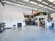 Spacious garage with epoxy flooring and overhead storage racks for organization at 15037 Montello Way, Lakewood Ranch, FL 34211