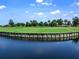 Picturesque view of a well-maintained golf course alongside a tranquil lake reflecting the surrounding trees at 15037 Montello Way, Lakewood Ranch, FL 34211