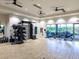 Large gym with various equipment, ceiling fans, and access to an outdoor patio area at 15037 Montello Way, Lakewood Ranch, FL 34211