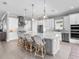 Bright kitchen with white cabinets, quartz countertops and a large island with pendant lighting at 15037 Montello Way, Lakewood Ranch, FL 34211