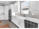 Bright kitchen features stainless steel appliances, farmhouse sink, and shaker cabinets at 15037 Montello Way, Lakewood Ranch, FL 34211