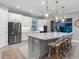 Gourmet kitchen with white cabinets, center island with seating, and modern stainless steel appliances at 15037 Montello Way, Lakewood Ranch, FL 34211