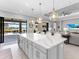 Spacious kitchen with large island, stainless appliances, and seamless flow to outdoor living space at 15037 Montello Way, Lakewood Ranch, FL 34211