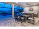 Outdoor dining area on the lanai overlooking the pool and lake views at 15037 Montello Way, Lakewood Ranch, FL 34211