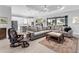 Spacious living room features modern furnishings, neutral colors, and an open layout to the kitchen at 15037 Montello Way, Lakewood Ranch, FL 34211