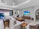 Comfortable living room with neutral tones, large sectional, and a view of the outdoor living space at 15037 Montello Way, Lakewood Ranch, FL 34211