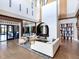 Elegant lobby area featuring modern decor, a fireplace, comfortable seating, and wood plank floors at 15037 Montello Way, Lakewood Ranch, FL 34211