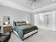An elegant main bedroom offers a ceiling fan, a walk-in closet, and an ensuite bathroom at 15037 Montello Way, Lakewood Ranch, FL 34211
