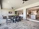 Inviting outdoor patio with ceiling fans and a dining area with an open view to the light and airy kitchen at 15037 Montello Way, Lakewood Ranch, FL 34211