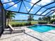 Inviting pool with sun loungers overlooking a serene lake and golf course, perfect for relaxation at 15037 Montello Way, Lakewood Ranch, FL 34211