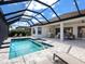This screened lanai has a stunning pool and backyard, complete with outdoor seating and patio at 15037 Montello Way, Lakewood Ranch, FL 34211