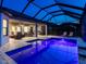 Large screened pool area with outdoor living space and a covered patio at dusk at 15037 Montello Way, Lakewood Ranch, FL 34211