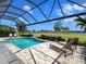 Leisure pool surrounded by well-maintained landscaping and a stunning view of the green fairways beyond at 15037 Montello Way, Lakewood Ranch, FL 34211