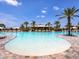 Beautiful community pool featuring a Bahama Bar, surrounded by lush landscaping and lounge chairs at 15037 Montello Way, Lakewood Ranch, FL 34211