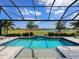 A gorgeous swimming pool area offers a serene view of the green golf course and blue lake at 15037 Montello Way, Lakewood Ranch, FL 34211