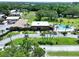 Community clubhouse with a sparkling pool, palm trees, and well-manicured landscaping at 1526 Mission Hills Blvd # 18B, Clearwater, FL 33759