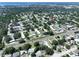 An aerial view of the community featuring mature trees, landscaping, and nearby street at 1526 Mission Hills Blvd # 18B, Clearwater, FL 33759