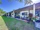 Villa back exterior with brick patio, perfect for relaxing and enjoying the beautifully maintained lawn and garden area at 1526 Mission Hills Blvd # 18B, Clearwater, FL 33759