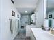 Bright bathroom featuring a shower with marble-style tile and grab bar for accessibility at 1526 Mission Hills Blvd # 18B, Clearwater, FL 33759