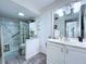 Bright bathroom with a vanity and a shower with marble-style patterned walls at 1526 Mission Hills Blvd # 18B, Clearwater, FL 33759