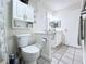 Bathroom featuring a toilet, vanity, and adjacent storage at 1526 Mission Hills Blvd # 18B, Clearwater, FL 33759