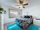 Bright bedroom featuring a ceiling fan, ample natural light, and carpet rugs at 1526 Mission Hills Blvd # 18B, Clearwater, FL 33759