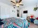 Bright bedroom features a ceiling fan, closet, and decor with fun and colorful bedding at 1526 Mission Hills Blvd # 18B, Clearwater, FL 33759