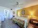 Inviting bedroom with a floral bedspread, ceiling fan, and easy access to an en-suite bathroom at 1526 Mission Hills Blvd # 18B, Clearwater, FL 33759