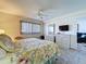 Bright bedroom with a floral bedspread, ceiling fan, and an ample amount of storage at 1526 Mission Hills Blvd # 18B, Clearwater, FL 33759