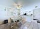 Dining area featuring a wicker table set and views of the kitchen and entry at 1526 Mission Hills Blvd # 18B, Clearwater, FL 33759