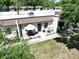 Charming condominium featuring a cozy front patio with seating and an umbrella for shade at 1526 Mission Hills Blvd # 18B, Clearwater, FL 33759