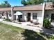 Inviting condo with a cozy front patio, seating, and beautiful landscaping at 1526 Mission Hills Blvd # 18B, Clearwater, FL 33759
