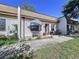 Charming villa with a quaint front patio, complete with seating and a lovely garden area, set on a sunny day at 1526 Mission Hills Blvd # 18B, Clearwater, FL 33759