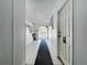 Hallway leads to the pool area with restrooms and community information board at 1526 Mission Hills Blvd # 18B, Clearwater, FL 33759