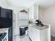 Charming kitchen featuring white cabinetry, granite countertops, and modern appliances at 1526 Mission Hills Blvd # 18B, Clearwater, FL 33759