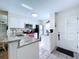 Renovated kitchen boasts white cabinetry, stainless steel appliances, and granite counters, offering a stylish and functional cooking space at 1526 Mission Hills Blvd # 18B, Clearwater, FL 33759