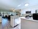 Bright and modern kitchen featuring white cabinets, granite countertops, and stainless steel appliances, seamlessly connecting to the living space at 1526 Mission Hills Blvd # 18B, Clearwater, FL 33759