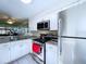 Updated kitchen with stainless steel appliances, granite countertops, and bright white cabinetry at 1526 Mission Hills Blvd # 18B, Clearwater, FL 33759